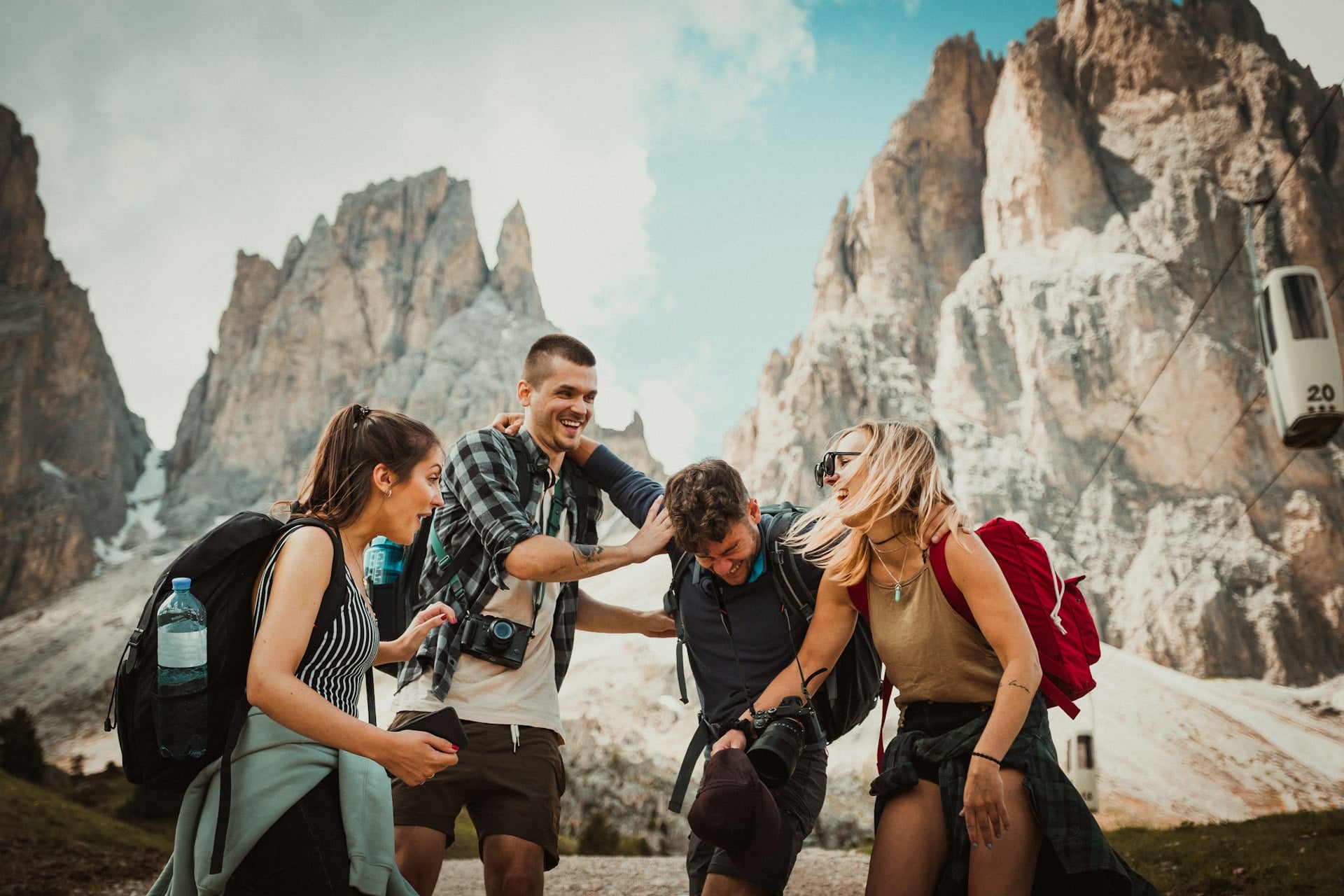 A group of friends laughing together on a mountain hike